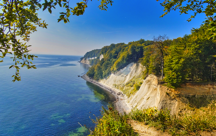 Kreidefelsen auf der Halbinsel Jasmund, Rügen, mit Blick auf die Ostsee und einen Strand.